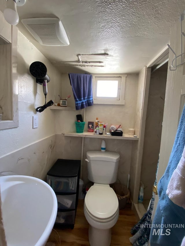 1138 Normal Ave, Burley, ID 83318 - bathroom featuring toilet, a sink, wood finished floors, and a textured ceiling