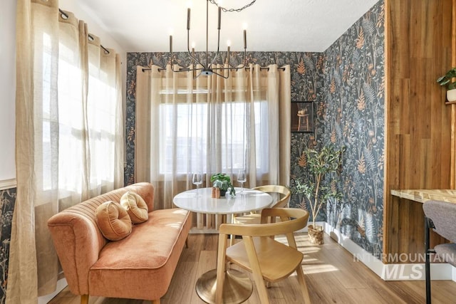 1138 Normal Ave, Burley, ID 83318 - dining area with a chandelier, wood finished floors, and wallpapered walls