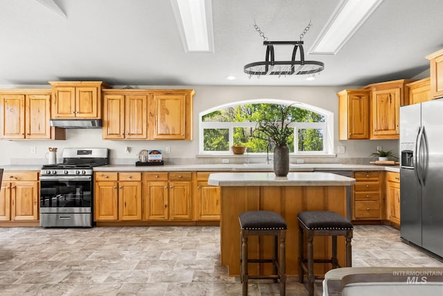 315 Bard Ave, Middleton, ID 83644 - kitchen featuring stainless steel appliances, under cabinet range hood, light countertops, stone finish flooring, and recessed lighting