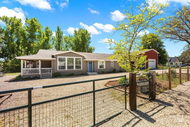 315 Bard Ave, Middleton, ID 83644 - ranch-style home featuring a fenced front yard, a porch, a detached garage, roof with shingles, and board and batten siding