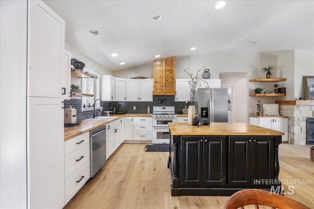 1827 Targhee Dr, Twin Falls, ID 83301 - kitchen with wooden counters, stainless steel appliances, open shelves, vaulted ceiling, and recessed lighting