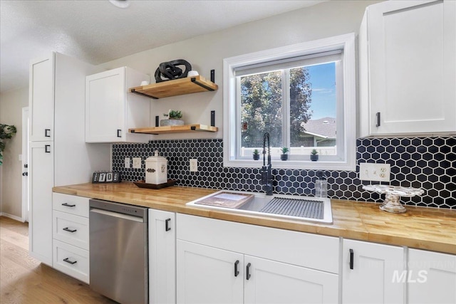 1827 Targhee Dr, Twin Falls, ID 83301 - kitchen with wood counters, stainless steel dishwasher, tasteful backsplash, white cabinetry, and light wood-style floors