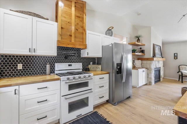 1827 Targhee Dr, Twin Falls, ID 83301 - kitchen featuring range with two ovens, wooden counters, stainless steel fridge with ice dispenser, white cabinets, and lofted ceiling