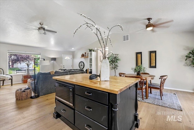 1827 Targhee Dr, Twin Falls, ID 83301 - kitchen featuring ceiling fan, black microwave, wood counters, dark cabinets, and a textured ceiling