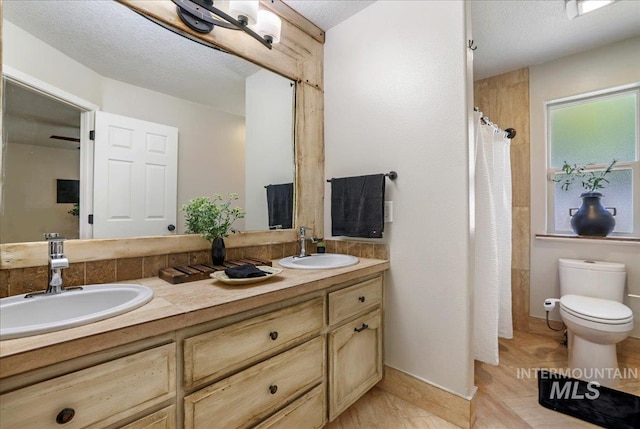 1827 Targhee Dr, Twin Falls, ID 83301 - bathroom featuring double vanity, a shower with shower curtain, and a textured ceiling