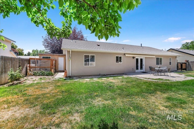 1827 Targhee Dr, Twin Falls, ID 83301 - back of house featuring a fenced backyard, stucco siding, a patio, and french doors