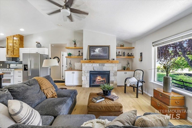 1827 Targhee Dr, Twin Falls, ID 83301 - living room with vaulted ceiling, a ceiling fan, a fireplace, light wood finished floors, and recessed lighting