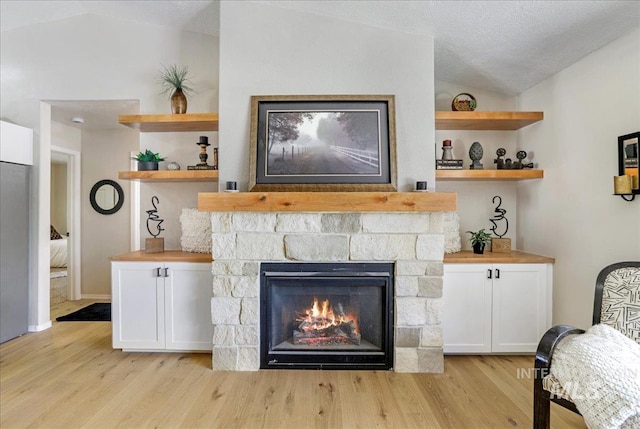 1827 Targhee Dr, Twin Falls, ID 83301 - living room featuring lofted ceiling, light wood finished floors, and a fireplace