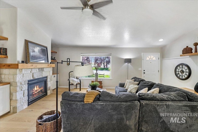 1827 Targhee Dr, Twin Falls, ID 83301 - living room with wood finished floors, a ceiling fan, and a fireplace