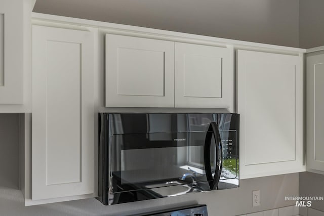 11922 W Box Canyon St, Star, ID 83669 - kitchen view of black microwave and white cabinets