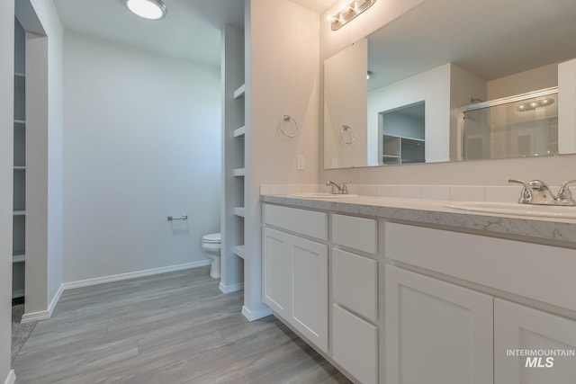 11922 W Box Canyon St, Star, ID 83669 - bathroom featuring a spacious closet, toilet, double vanity, a shower with shower door, and wood finished floors