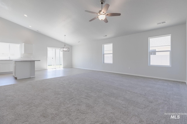 11922 W Box Canyon St, Star, ID 83669 - unfurnished living room with ceiling fan, vaulted ceiling, light carpet, and baseboards