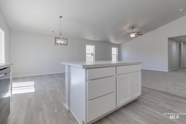 11922 W Box Canyon St, Star, ID 83669 - kitchen with open floor plan, stainless steel dishwasher, ceiling fan, white cabinets, and a center island