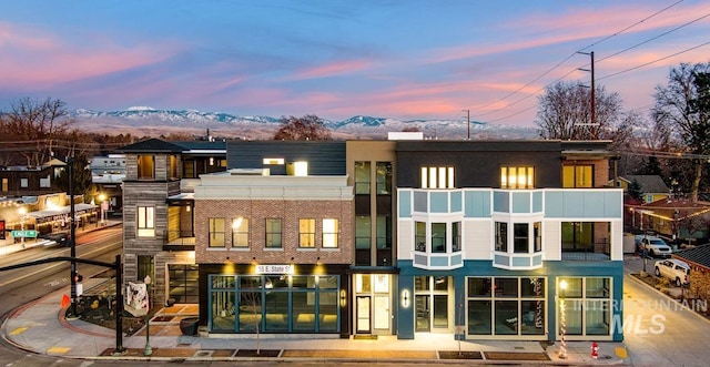 back house at dusk with a mountain view