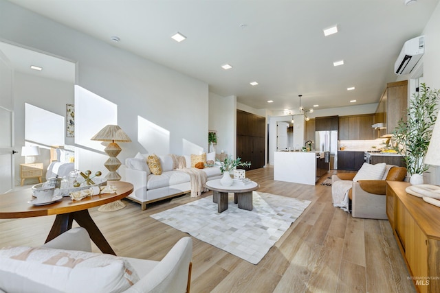 55 E State St Unit 303, Eagle, ID 83616 - living room featuring light hardwood / wood-style flooring and a wall mounted air conditioner