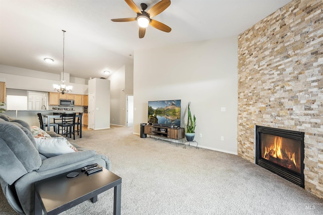 3189 S Kramer Ln, Boise, ID 83706 - living room featuring baseboards, a stone fireplace, high vaulted ceiling, light colored carpet, and ceiling fan with notable chandelier