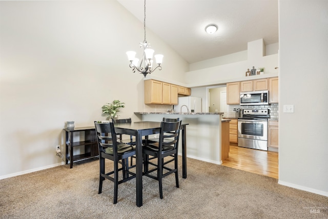 3189 S Kramer Ln, Boise, ID 83706 - dining area featuring a notable chandelier, light colored carpet, baseboards, and high vaulted ceiling
