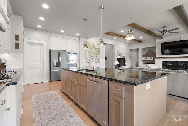 1315 N Luge Ave, Eagle, ID 83616 - kitchen featuring appliances with stainless steel finishes, a sink, a ceiling fan, beam ceiling, and an island with sink