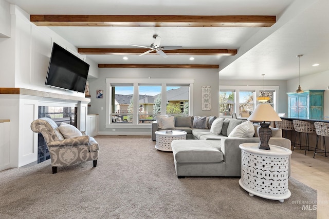 1315 N Luge Ave, Eagle, ID 83616 - living area featuring a ceiling fan, beamed ceiling, recessed lighting, a glass covered fireplace, and light carpet