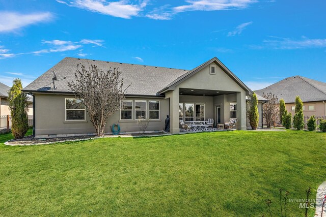 1315 N Luge Ave, Eagle, ID 83616 - back of property featuring stucco siding, a shingled roof, and a patio