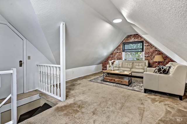 913 N 22nd St, Boise, ID 83702 - carpeted living area featuring vaulted ceiling, a textured ceiling, and brick wall