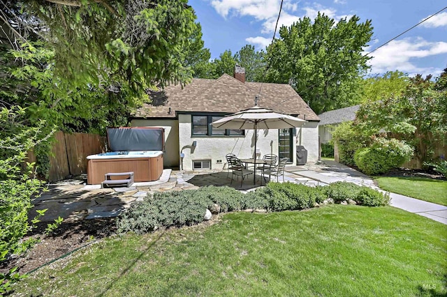 913 N 22nd St, Boise, ID 83702 - rear view of house with a hot tub, a patio, a chimney, a shingled roof, and stucco siding