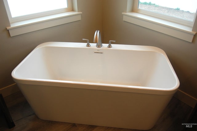 bathroom featuring a bathtub and hardwood / wood-style flooring