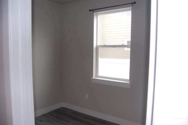 spare room with dark hardwood / wood-style floors