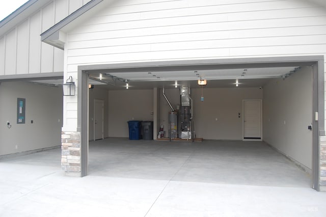 garage featuring a garage door opener, electric panel, and water heater