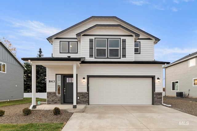 craftsman-style house featuring a garage and central AC unit