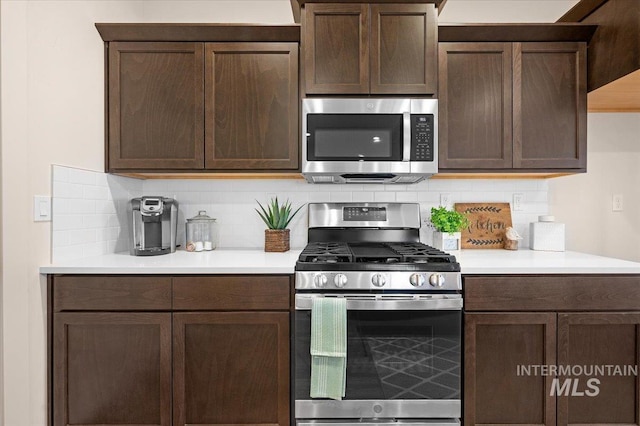 kitchen featuring dark brown cabinetry, backsplash, and stainless steel appliances