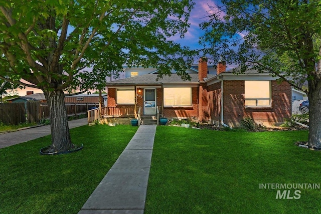 view of front of property featuring brick siding and a chimney