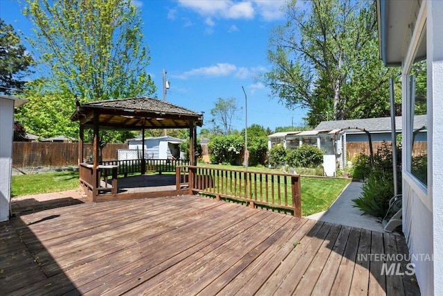 wooden terrace with a shed, an outbuilding, and a gazebo