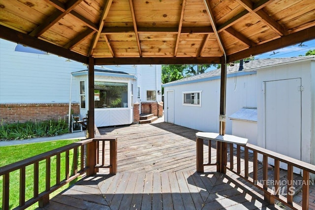 wooden deck featuring a gazebo and a lawn