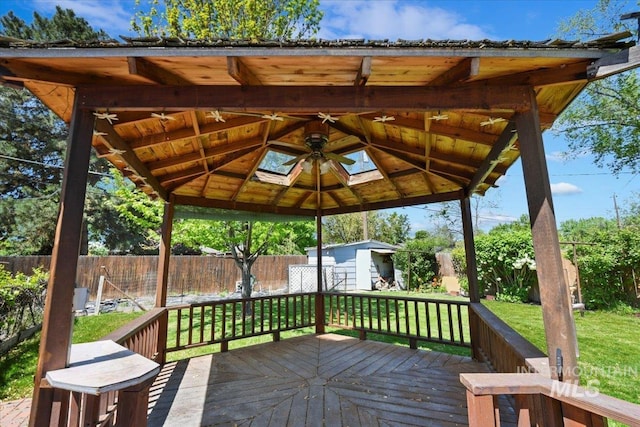 deck with a storage unit, an outbuilding, and a gazebo