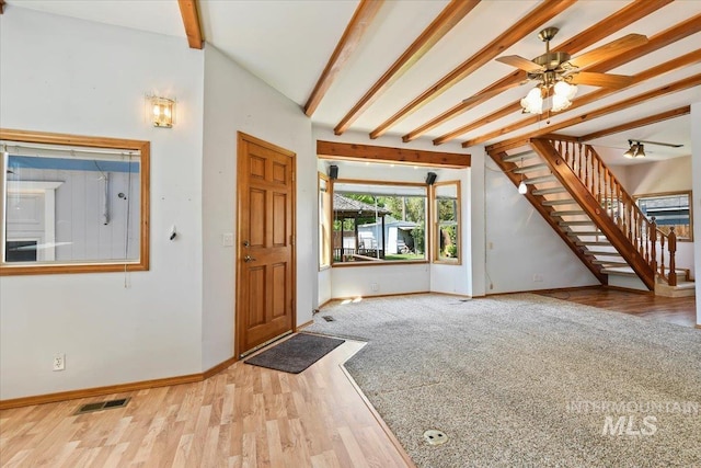 entryway featuring beam ceiling, stairs, wood finished floors, baseboards, and a ceiling fan