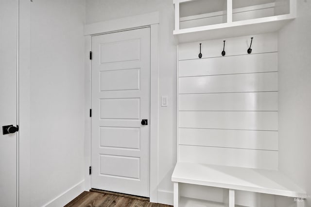 mudroom with dark wood-type flooring and baseboards