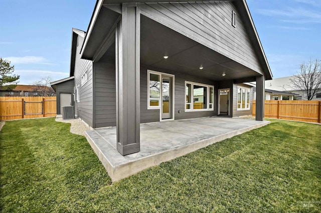 back of house with a patio area, a lawn, and a fenced backyard