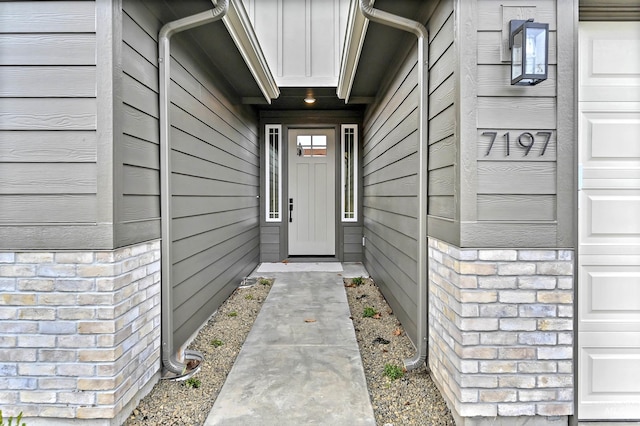 entrance to property with stone siding and board and batten siding