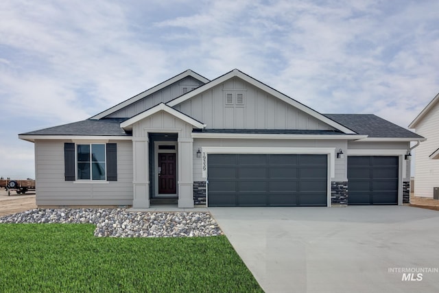 19339 Susquehanna Way, Caldwell, ID 83605 - view of front facade with a garage, board and batten siding, concrete driveway, a shingled roof, and a front lawn