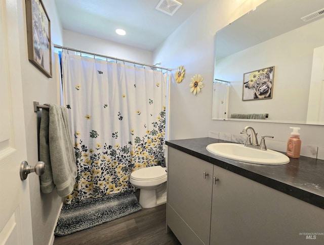 19339 Susquehanna Way, Caldwell, ID 83605 - bathroom with vanity, toilet, wood finished floors, curtained shower, and recessed lighting