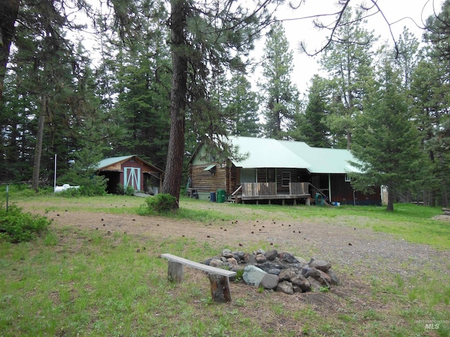 3695 W Mountain Rd, Anatone, WA 99401 - cabin with a fire pit, a storage shed, an outbuilding, metal roof, and log siding
