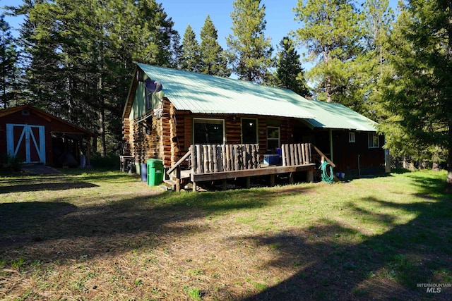 3695 W Mountain Rd, Anatone, WA 99401 - back of property with a lawn, a storage shed, an outdoor structure, and metal roof