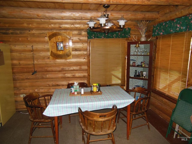 3695 W Mountain Rd, Anatone, WA 99401 - dining space with log walls, wood ceiling, and carpet floors