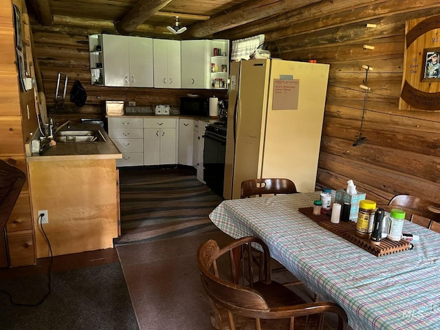 3695 W Mountain Rd, Anatone, WA 99401 - kitchen with black appliances, a sink, white cabinets, rustic walls, and wood ceiling