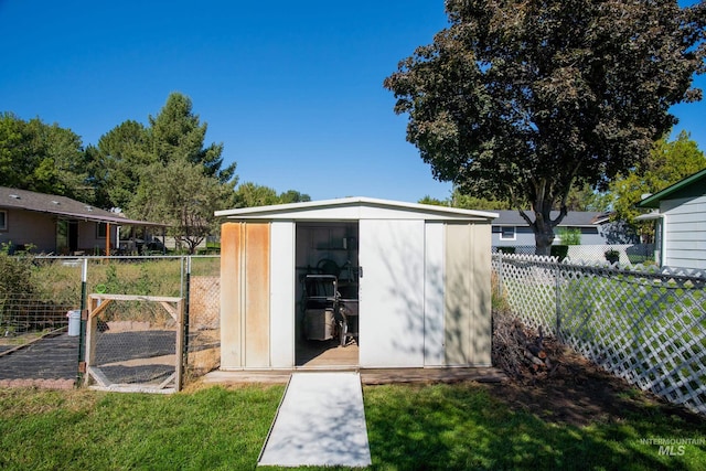 view of outbuilding with a yard