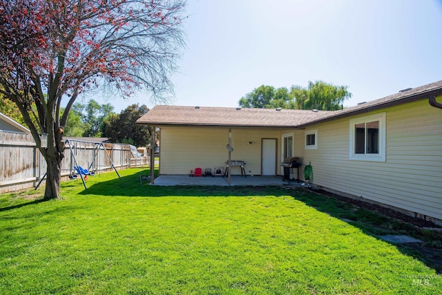 rear view of property with a patio area and a yard