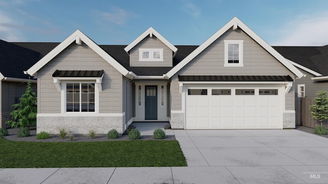 craftsman house featuring a front yard and a garage