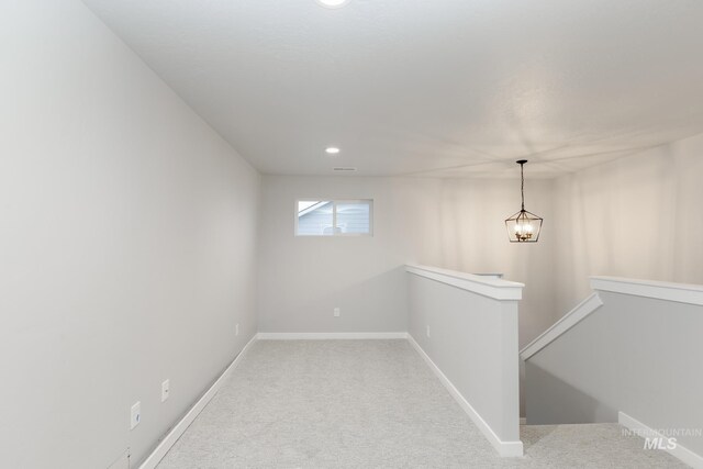 interior space with carpet flooring, an upstairs landing, baseboards, and recessed lighting
