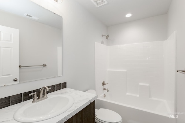 bathroom featuring vanity, toilet, bathing tub / shower combination, and visible vents